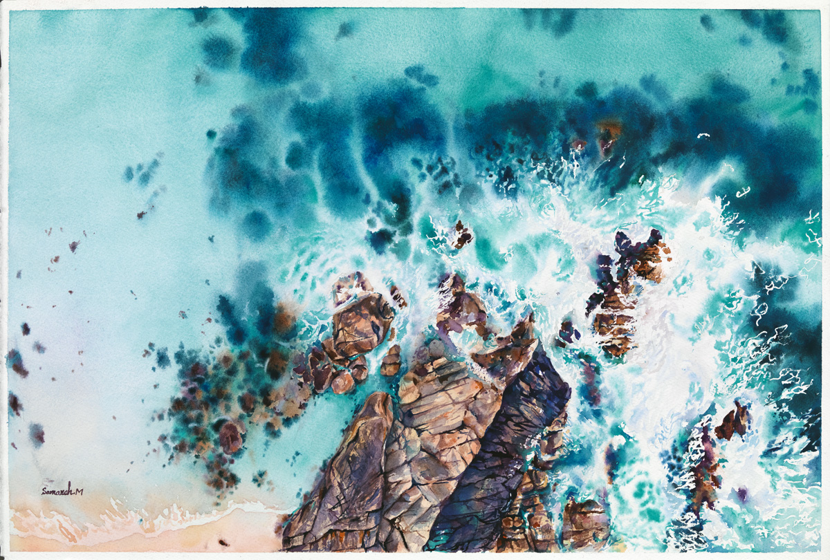 Turquoise sea washing around coastal rocks, seen from above